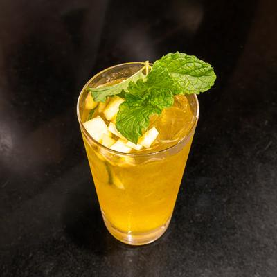 Mango mocktail, garnished with mint leaves.
