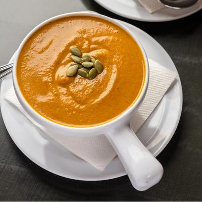 Pumpkin bisque topped with pumpkin seeds.