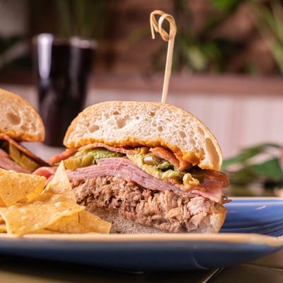 Cuban Torta, with pork, ham, bacon, avocado, jalapenos, chipotle mustard, and garlic aioli.