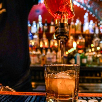 Employee pouring drink.