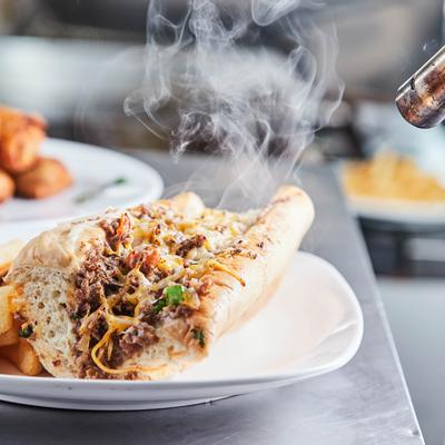 Cheese steak served with fries