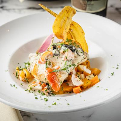 Chilean Seabass, with black truffle risotto, root vegetables, and white wine sauce.