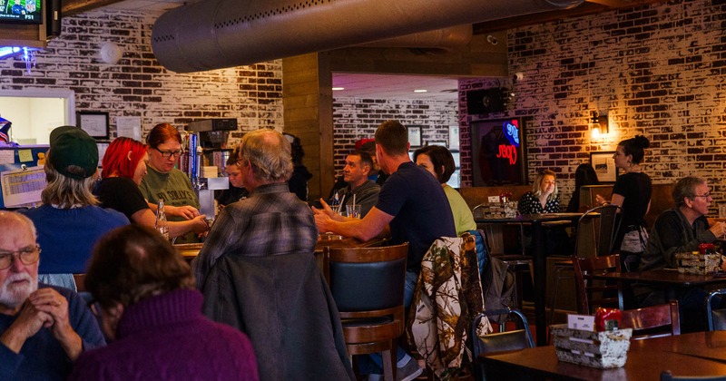 Interior, customers and staff in bar area