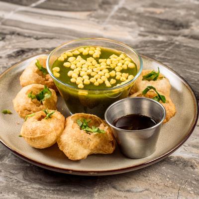 Deep fried puri shells served with pani flavored water.