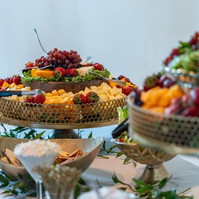Interior, fresh fruit trays and tableware on a buffet table.