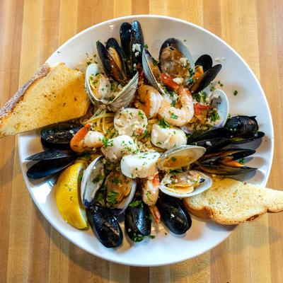 Seafood platter, with clams, mussels, shrimp, scallops, pasta, and garlic bread.