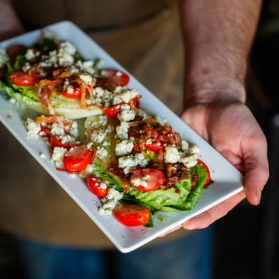Wedge Salad on a rectangular white plate.