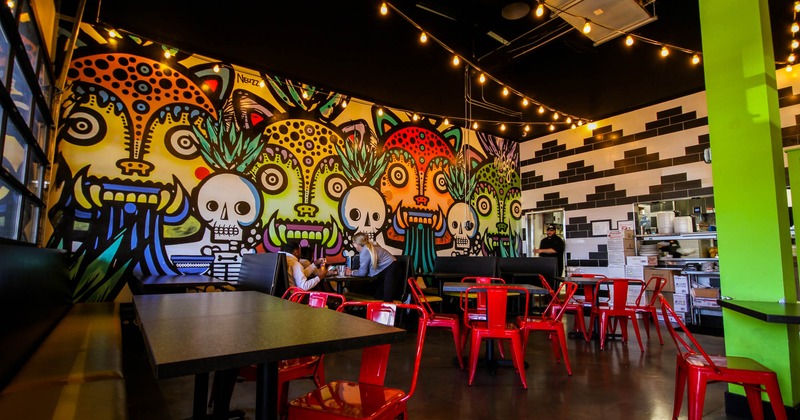 Interior, dining tables and booths, colorful mural art
