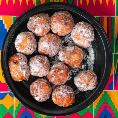 African ball shaped dessert covered in powdered sugar, top view