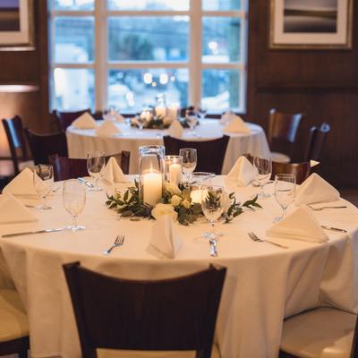Fully set dining table with white tablecloth.