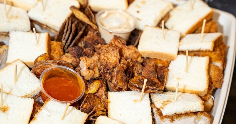 Platter of sandwiches, fried chicken and dipping sauce