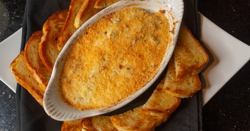 Spinach Artichoke Cheese Dip, served with toast, top view