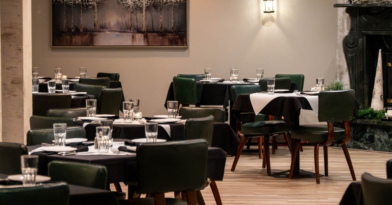 Interior, wide view of dining area, tables ready for guests