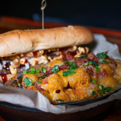 Brisket sandwich served with cheesy bacon tater tots.