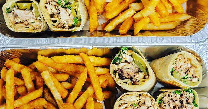 Halved chicken wraps with fries