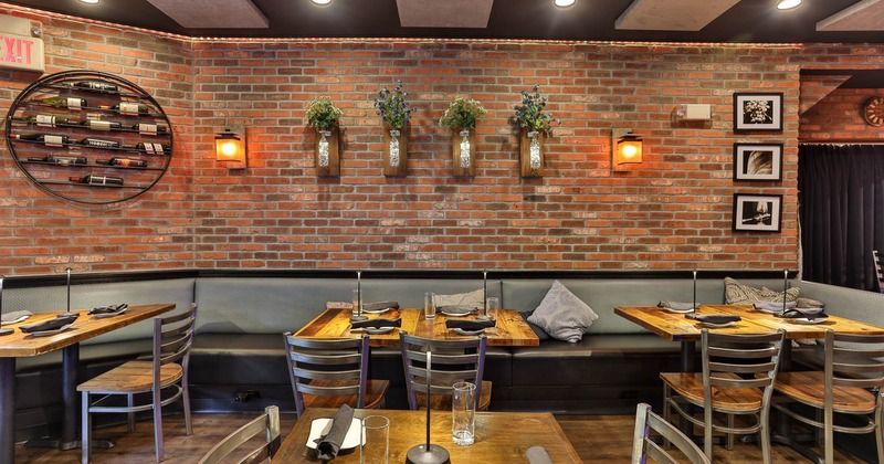 Dining tables placed against the decorated wall