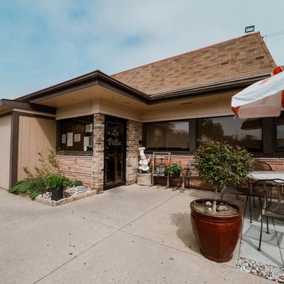 Exterior with signage and a potted plant.