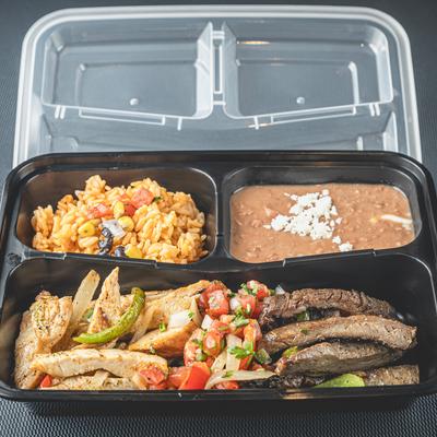 Lunch box with grilled steak, chicken, salsa, rice, and refried beans.