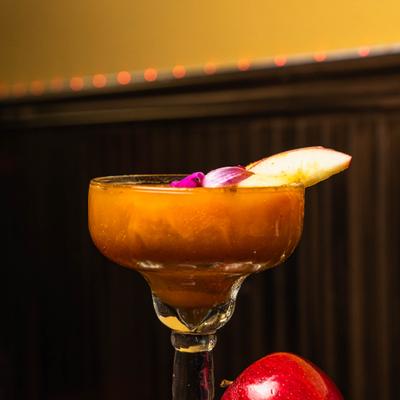 Pumpkin spice cocktail served in margarita glass.