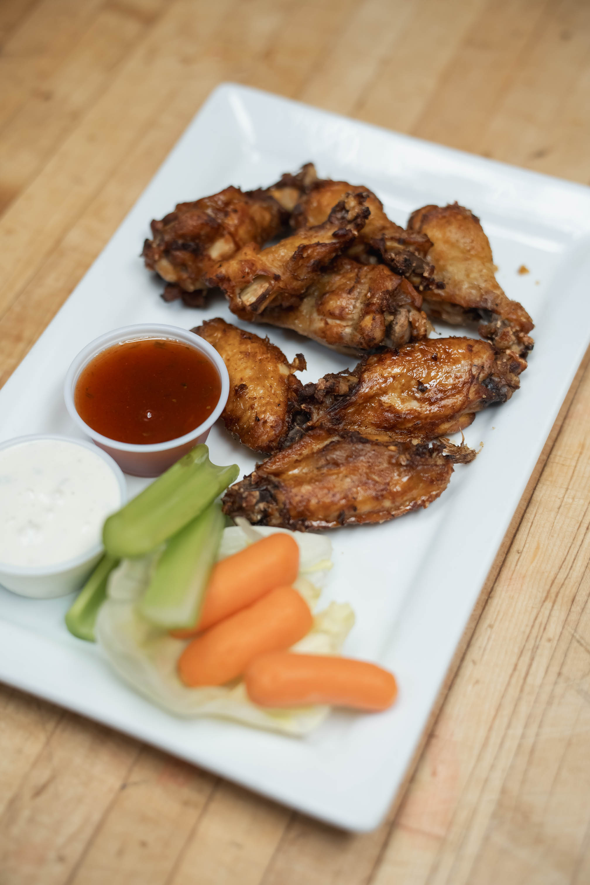 Smoked chicken wings, with carrots, celery, and dipping sauces