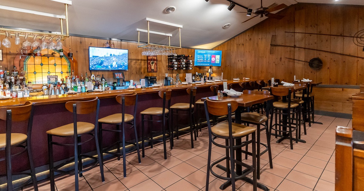 Interior, high tables and chairs near bar