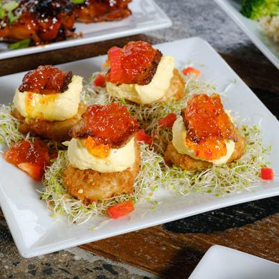 Fried deviled eggs with pork belly & pepper jelly drizzle.