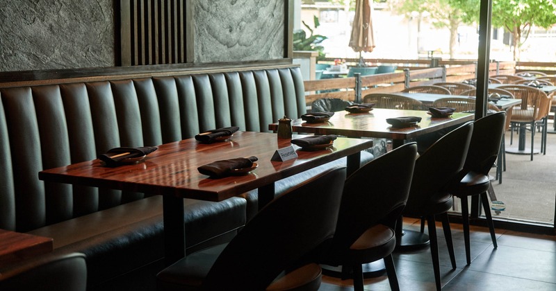 Interior, banquette bench with high gloss wooden top tables and chairs