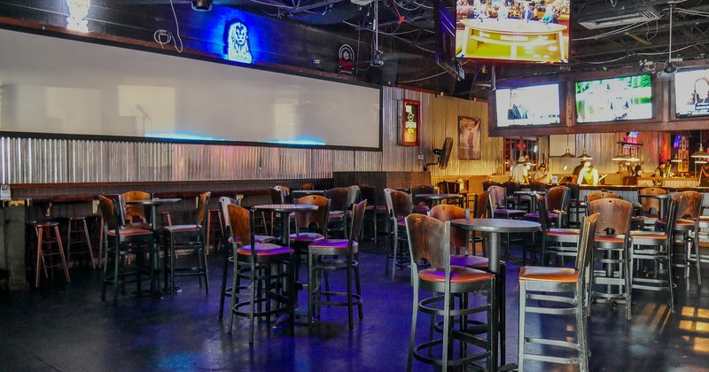 Sport bar interior space, seating area, high tables and stools