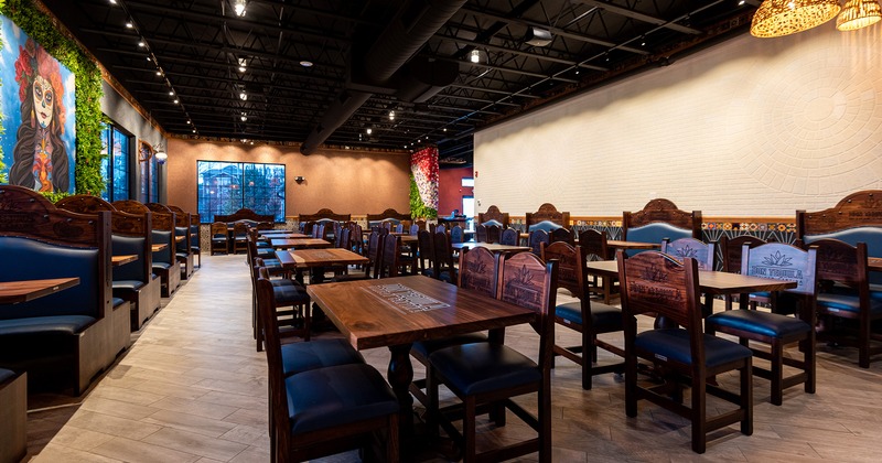 Interior space, cozy dining area with a lot of dining tables ready for guests