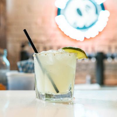 Margarita cocktail served in a rocks glass with a salted rim and lime garnish.