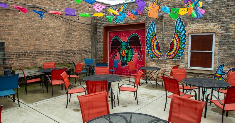 Exterior, tables and chairs, murals on the wall