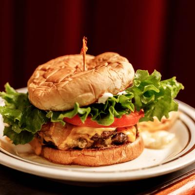 Cheeseburger with lettuce, tomato, served with fries.