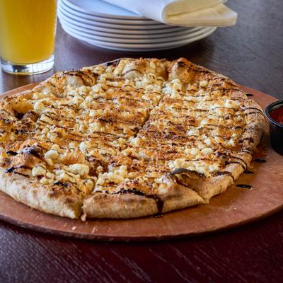 Goat cheese pizza with balsamic drizzle.