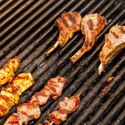 Grilled meats cooking over open flames.