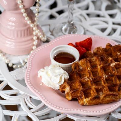 Two pearl sugar waffles with maple syrup.
