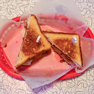 Country Fried BLT sandwich, sliced in half and served.