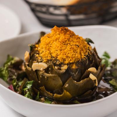 Stuffed artichoke with toasted breadcrumbs and almonds served on mixed greens.
