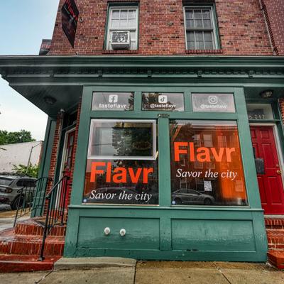 Restaurant, exterior with a prominent green-painted storefront and signage on windows.