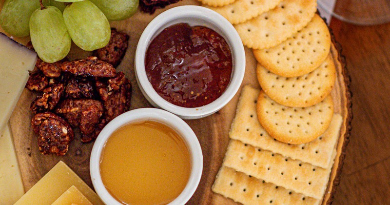 Cheese board with various condiments and fruits