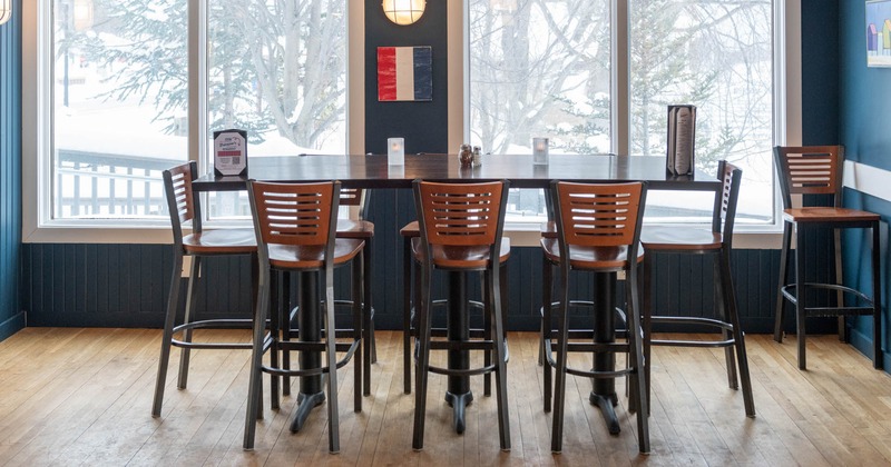 Interior, a bar table with bar stools in front of the windows