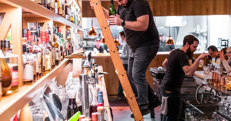 Interior, back bar, bartenders in action