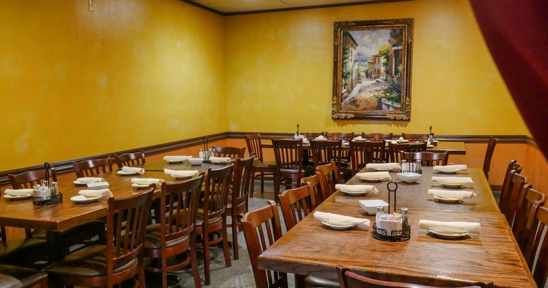 Interior, private dining area, wooden top tables with wooden chairs for ten people