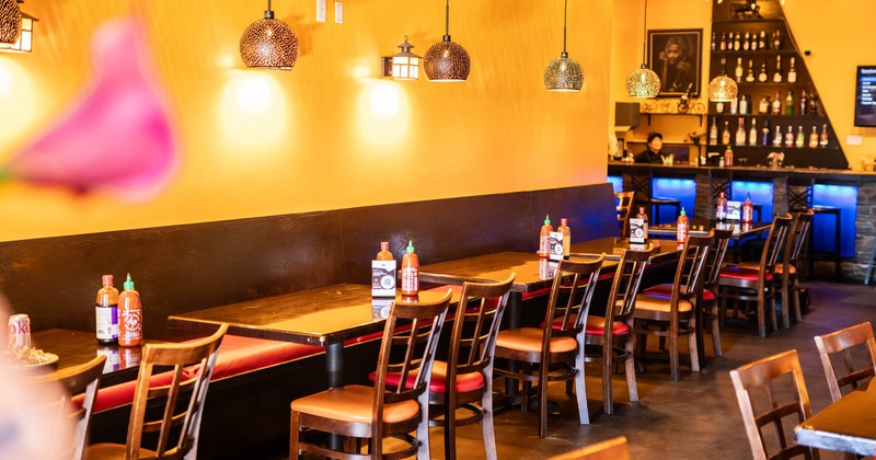 Interior, seating area with banquette seating, tables and chairs