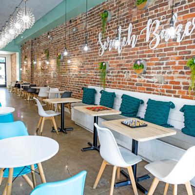 Tables and seats inside of the bakery.