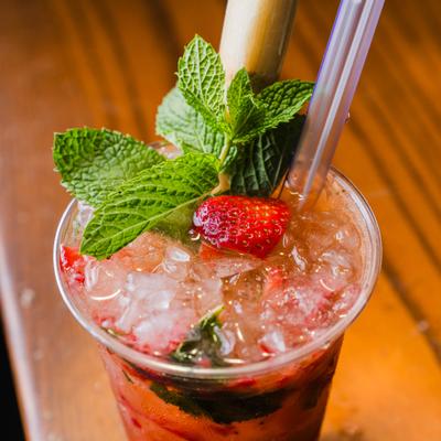 Strawberry Mojito garnished with fresh strawberry and a mint spring.