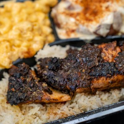 Jerk salmon, with rice, and sides.