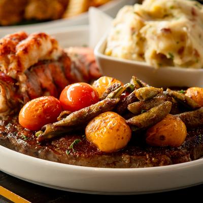 A closeup on the ribeye lobster meal.