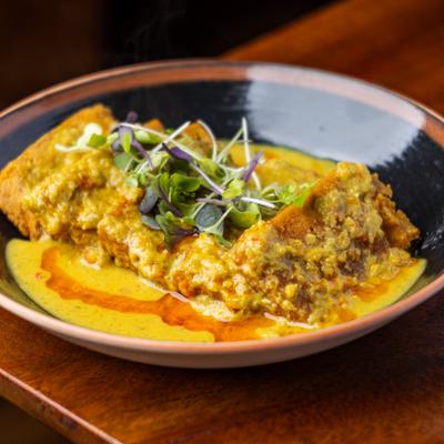 A plate of chickpea tofu, served with coconut garlic chili sauce.