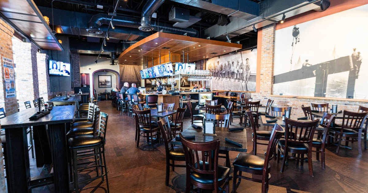 Interior, tables and seating near a bar