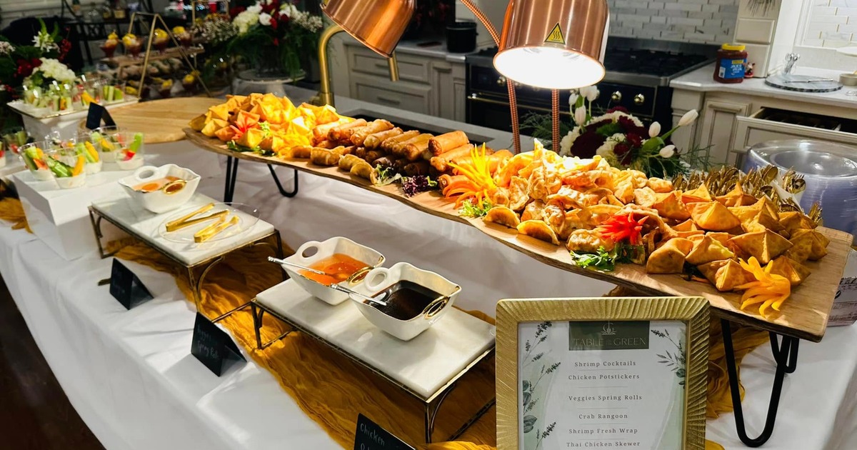 A long open table filled with served food